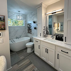 A bathroom mirror and sink area incorporates long white cabinets with black handles