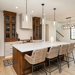 A kitchen interior that incorporates natural wood cabinetry on the walls and center island