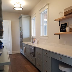 A kitchen interior with an oven and microwave built into the cabinetry