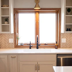 A kitchen window that features cube-shaped shelves hanging on either side