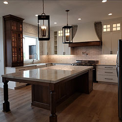 The interior of a kitchen that blends white cabinetry with natural woodwork