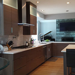 A kitchen interior with wood-toned cabinetry on the floor and walls
