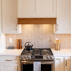 White kitchen cabinetry with a wooden accent